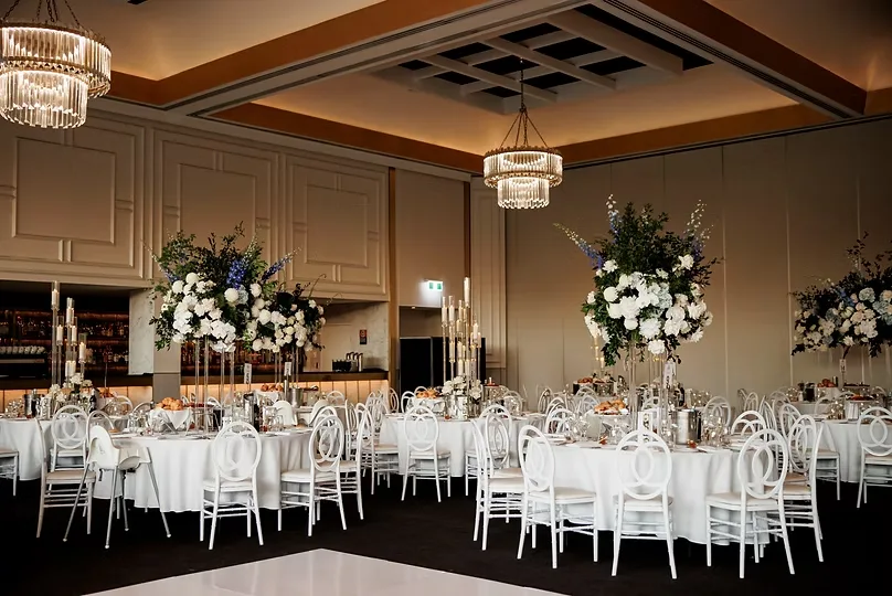 Ballroom wedding reception in Sydney with tall white and blue floral centrepieces